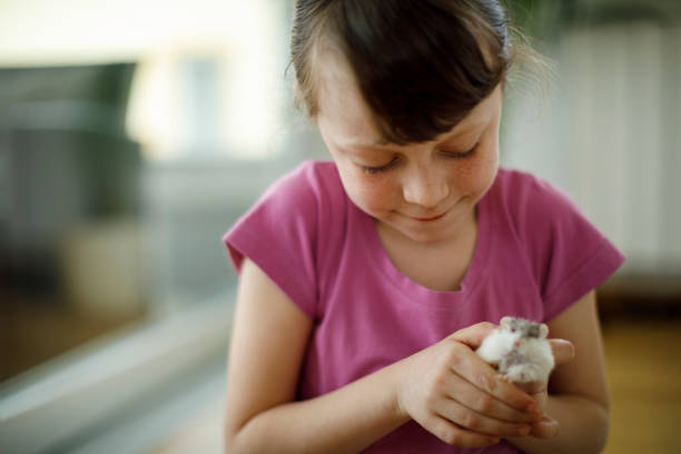 Adorable little girl holding her hamster