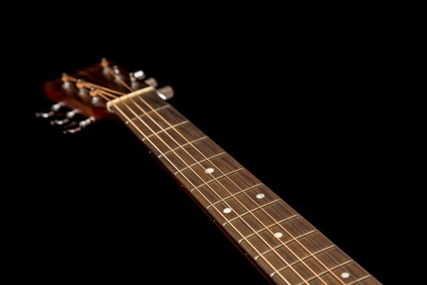 istock Head of guitar on black 670137034