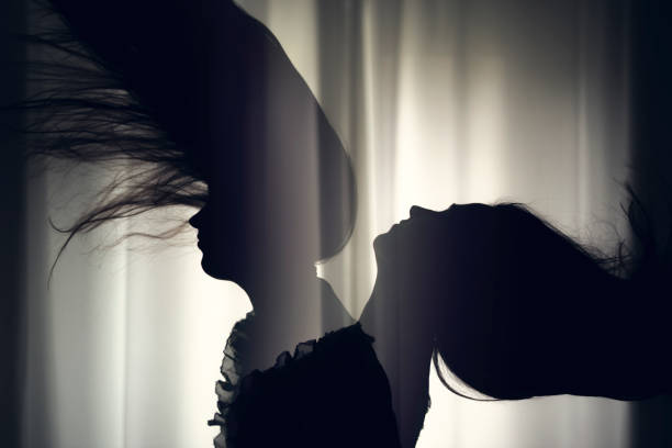 istock women hair silhouette at window 670146366