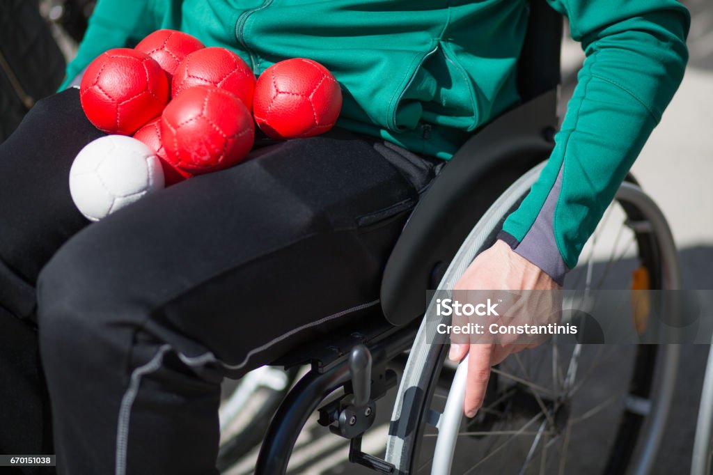 man in a wheelchair man in wheelchair with balls Boccia Stock Photo