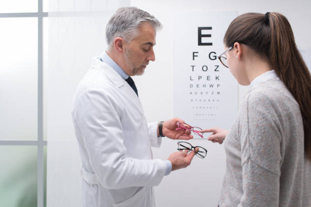 istock Woman choosing a pair of glasses 670151374