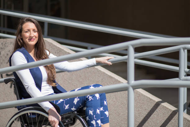 istock wheelchair ramp help for a young woman 670159848
