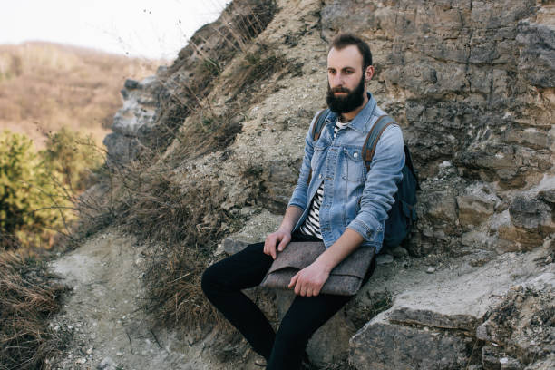 istock tourist man resting in the mountains while ascending to the top 670163148