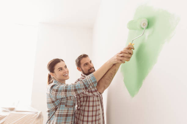 istock Loving couple painting together 670165504