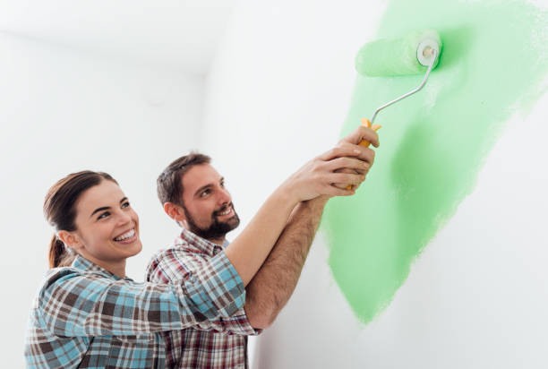 istock Loving couple painting together 670169070