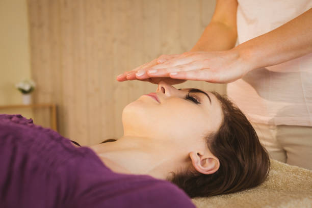 istock Young woman having a reiki treatment 670170666