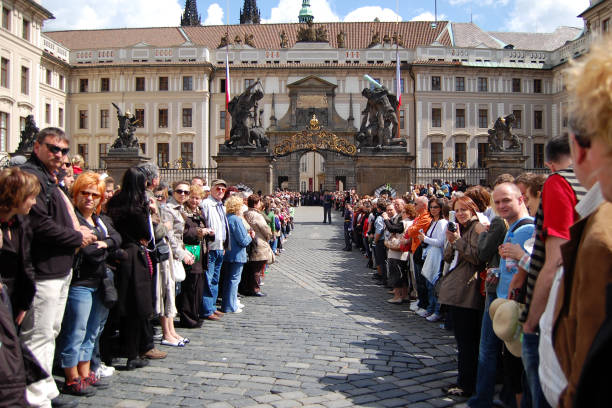 Tourists waiting for a guards change at Hradcany Square making way to the Hradcany Castle