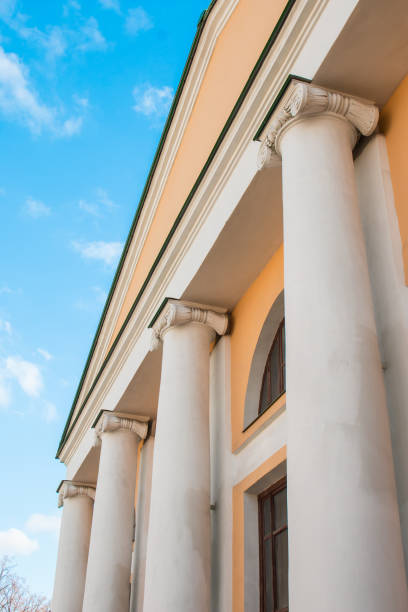 istock Facade of an old building with large white columns bright sunny day blue sky 670171204