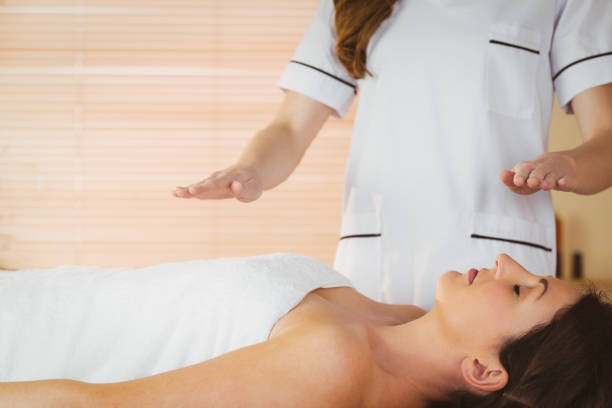 istock Young woman having a reiki treatment 670171206