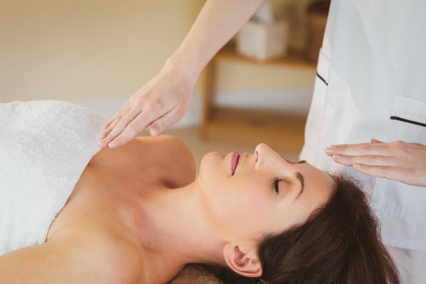 istock Young woman having a reiki treatment 670171282