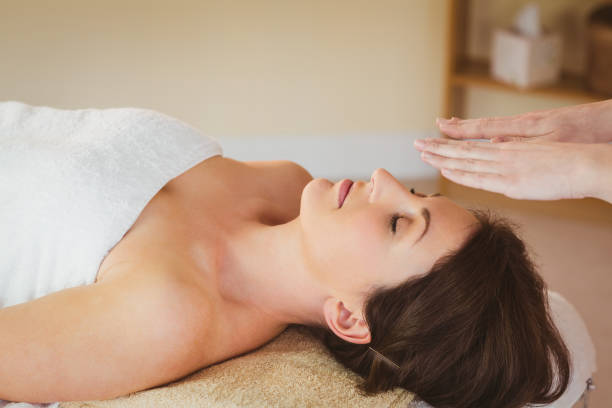 istock Young woman having a reiki treatment 670171396