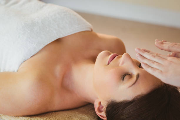 istock Young woman having a reiki treatment 670171600
