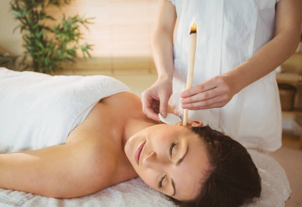 istock Young woman getting an ear candling treatment 670184494
