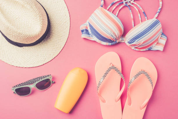 istock Summer background with straw hat, flip flops, swimsuit and sunglasses. 670194924