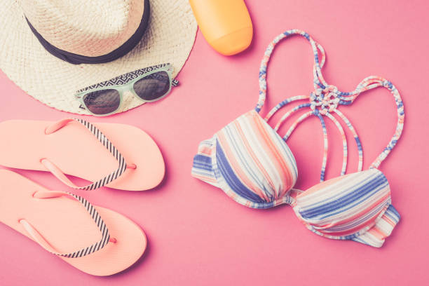 istock Summer background with straw hat, flip flops, swimsuit and sunglasses. 670201302