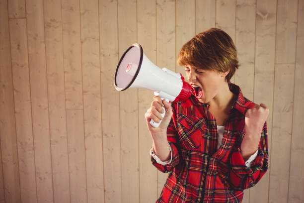 istock Pretty young woman using megaphone 670202760