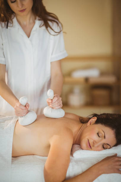 istock Young woman getting herbal compress massage 670210300