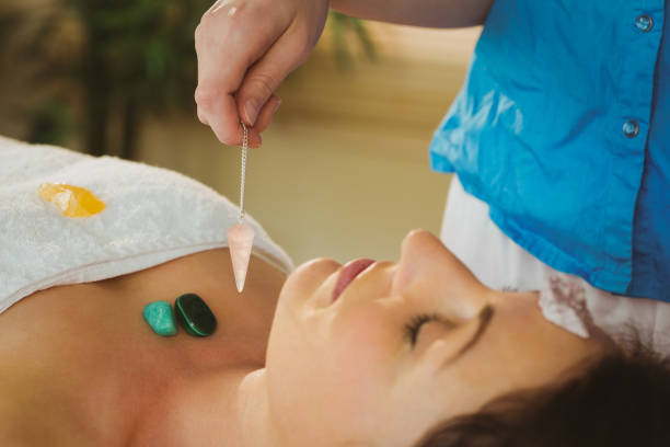istock Young woman at crystal healing session 670210352
