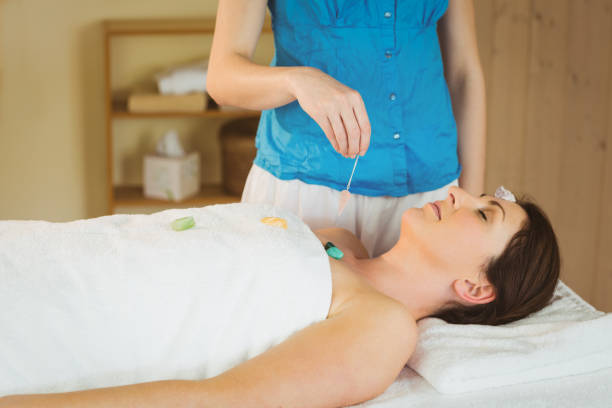 istock Young woman at crystal healing session 670210396