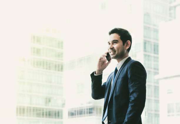 istock Businessman using mobile phone near office window at office building,communication concept,vintage filter 670212980