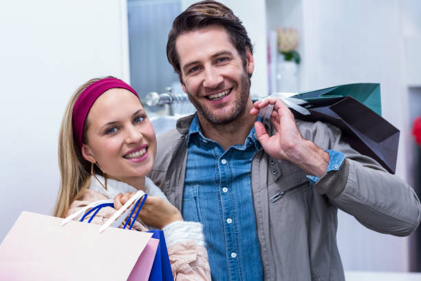 istock Smiling couple with shopping bags 670215892