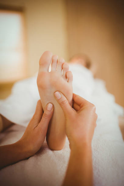 Young woman getting foot massage in therapy room
