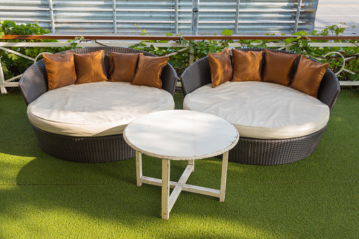 A modern wicker garden sofa or love seat