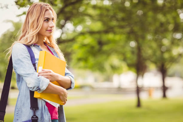 istock Smiling woman carrying bag and file 670224746