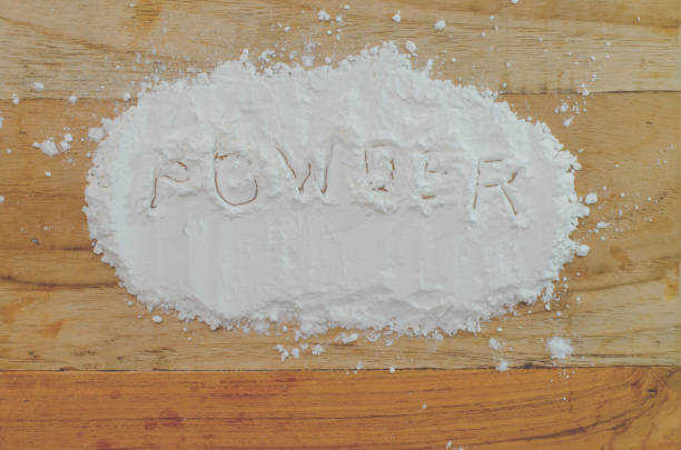 istock white flour on wooden table, top view 670228220