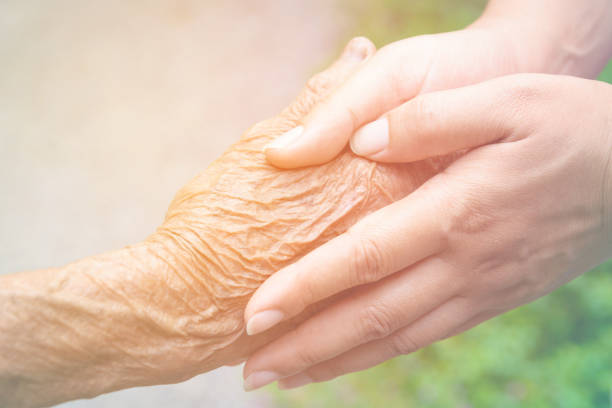 istock Senior and young holding hands with vintage color tone 670228376