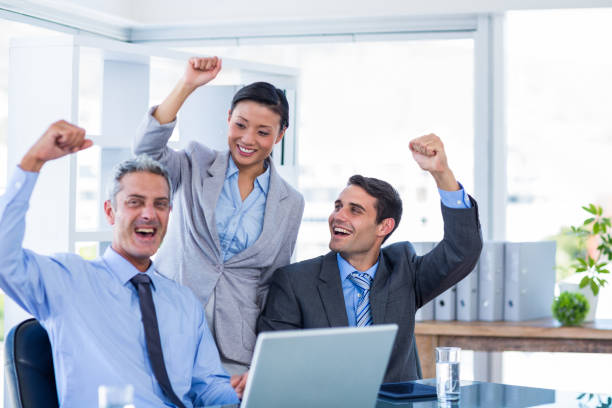 istock Happy business people cheering together 670229742
