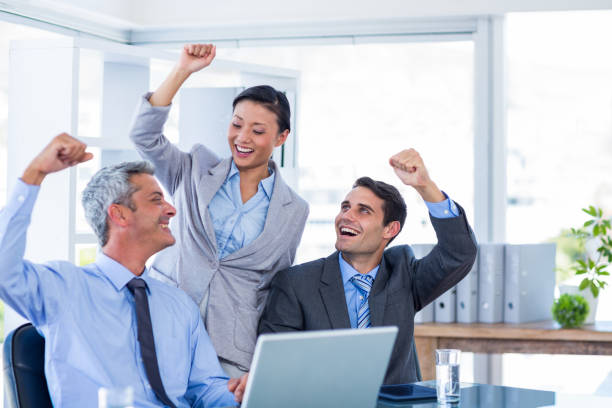 istock Happy business people cheering together 670229790
