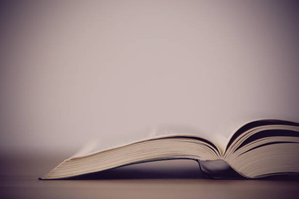 istock An opened holy bible on a wooden table 670235750