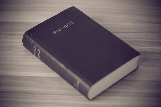 istock Holy Bible On Wooden Table 670235754