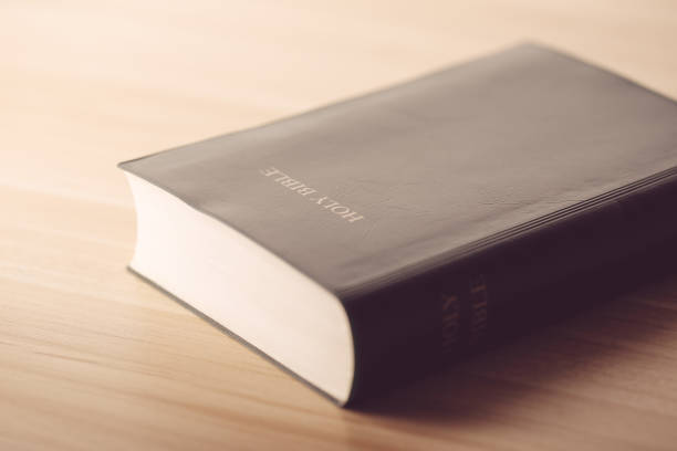 istock Holy Bible On Wooden Table 670235762