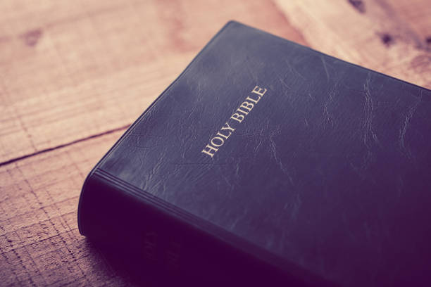 istock Holy Bible On Wooden Table 670235766