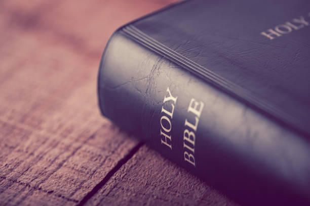 istock Holy Bible On Wooden Table 670236238