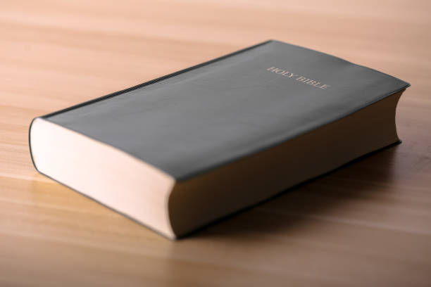 istock Holy Bible On Wooden Table 670236240