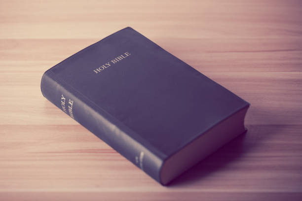 istock Holy Bible On Wooden Table 670236244