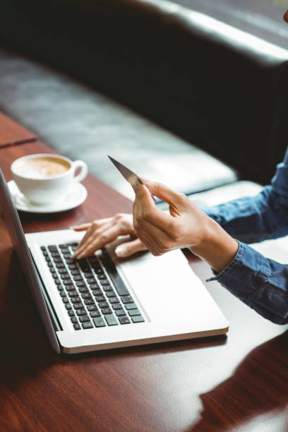 istock Student using laptop in cafe to shop online 670237300