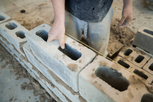 istock Mason who lays a cinder block 670237784