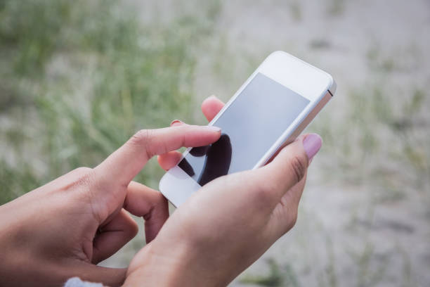 istock Beautiful woman using her smartphone 670244134