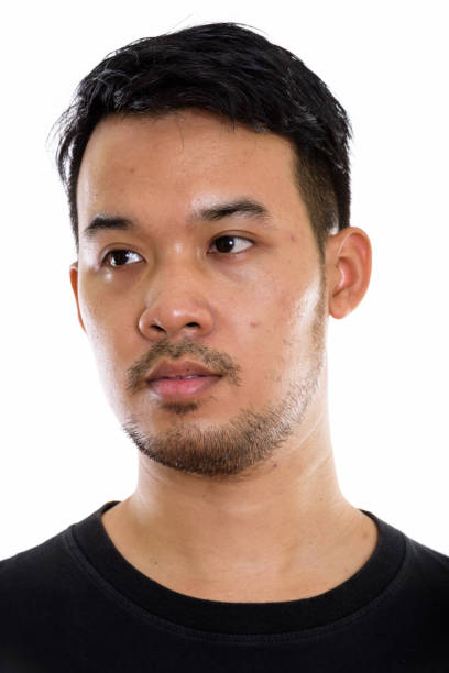 istock Face of young Asian man thinking while looking at distance 670246828