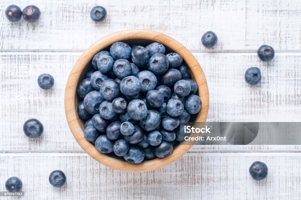 Top view of fresh blueberries in bowl Bowl of fresh blueberries on vintage white background. Top view Blueberry Stock Photo