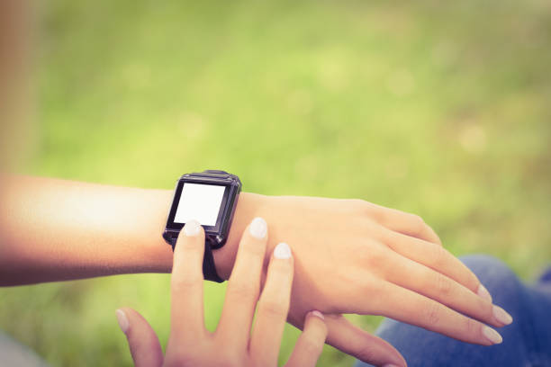 istock High angle view of woman touching smart watch 670251288
