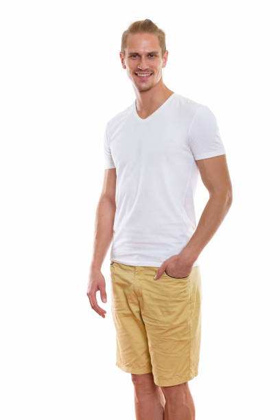 istock Studio shot of happy young handsome man smiling while standing with hand on pocket 670254692