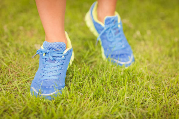 istock Low section of person walking on grass 670254998