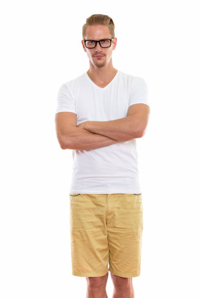 istock Young handsome man standing while wearing eyeglasses with arms crossed 670255104