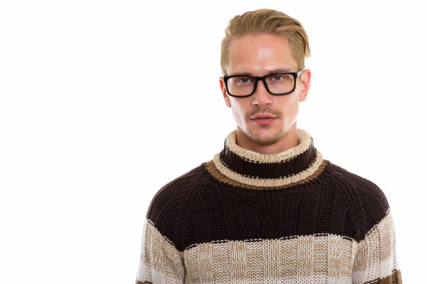 Cheerful funny looking nerdy guy with ginger hair and eyeglasses having beard.