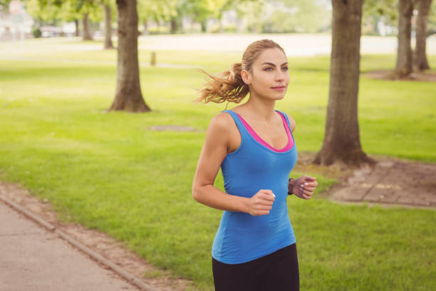 istock Confident woman running  in park 670256152